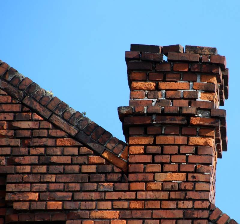 Damaged chimney on an Sunrise home showing cracks and missing mortar